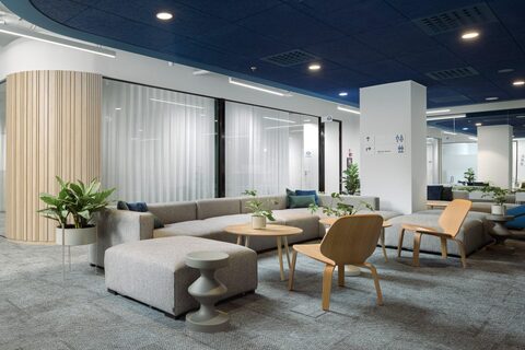 a room with a couch and chairs