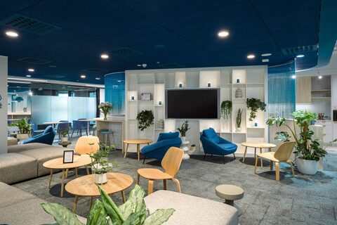a room with blue chairs and tables