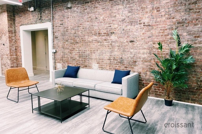 a chair sitting in front of a brick building