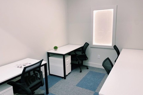 a bedroom with a bed and desk in a room