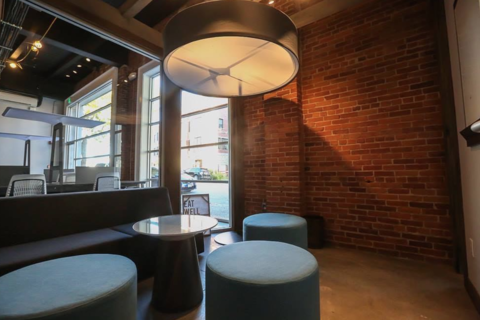 a room with brick walls and a large window