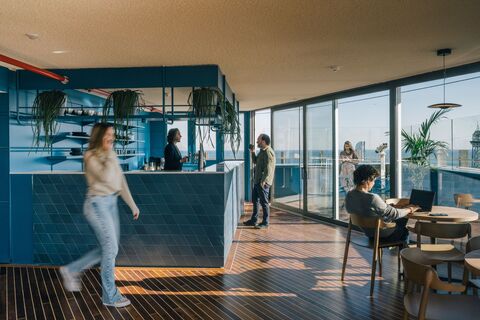 a group of people in a room with a bar and a table