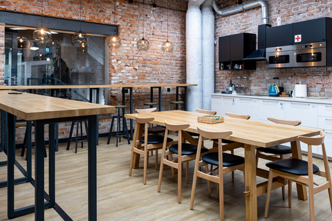 a room with a brick wall and a table and chairs