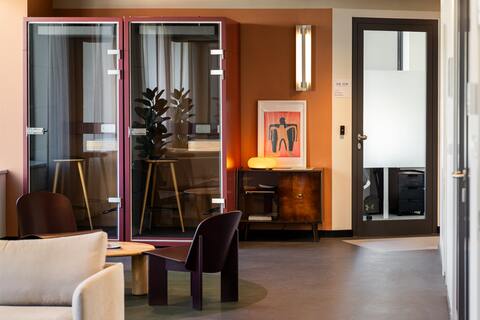 a room with a glass wall and a couch