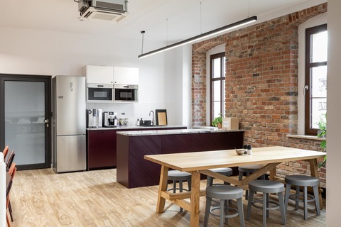 a kitchen with a table and a refrigerator