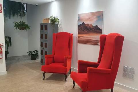 a living room filled with furniture and a fire place sitting in a chair
