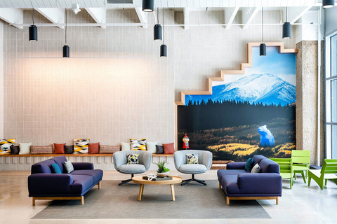 a room with a couch and table in front of a building