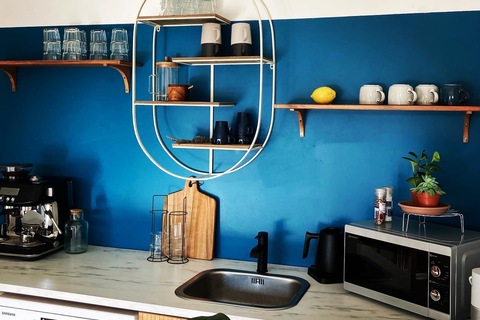 a kitchen with a blue background