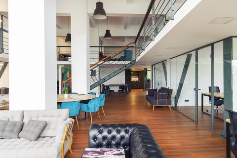 a room filled with furniture and a table in front of a building