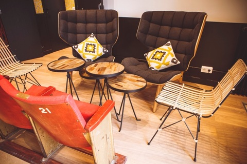 a living room with a leather chair sitting on top of a wooden table