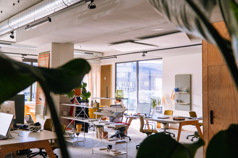 a room with a desk and chairs