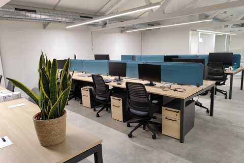 a room with computers and chairs