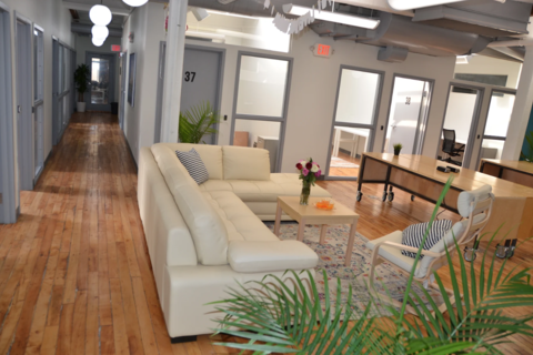 a living room filled with furniture and a large window