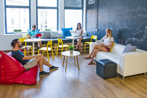 a group of people sitting around a living room