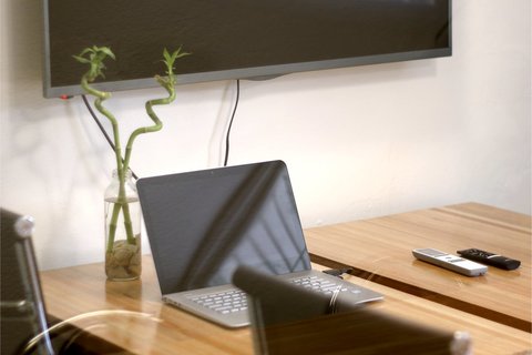 a laptop computer sitting on top of a wooden table