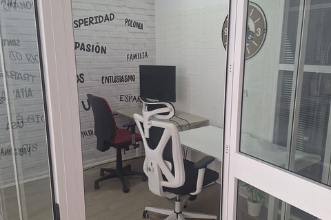 a glass door with a desk and chair in a room