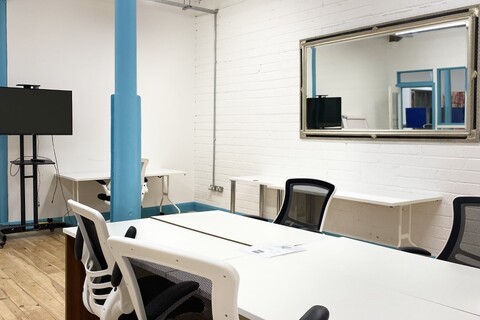 a bedroom with a bed and desk in a room