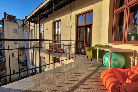 a balcony with chairs and a table