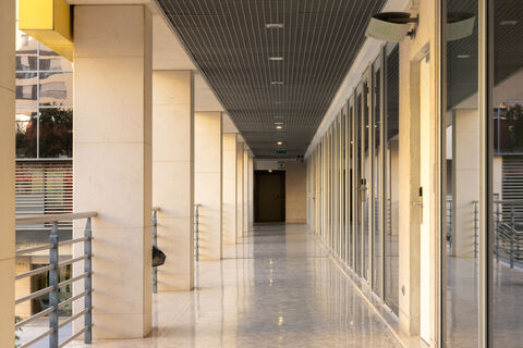 a hallway with glass doors and a metal ceiling