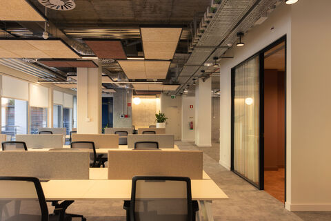 a room with white tables and chairs