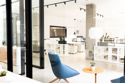 a room filled with furniture and a large window