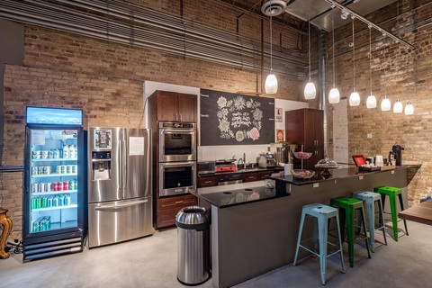 a kitchen area with a building in the background