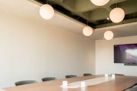 a conference room with a table and chairs