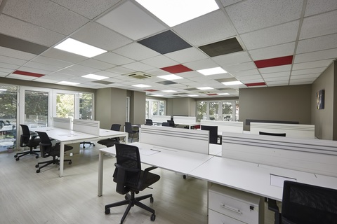 an office with a desk and chair in a room