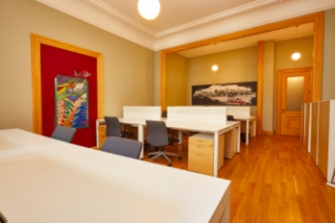 a bedroom with a bed and desk in a room