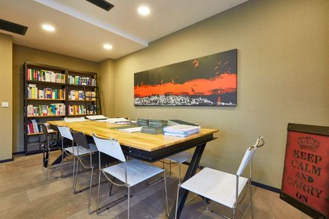 a room filled with furniture and a table in a library