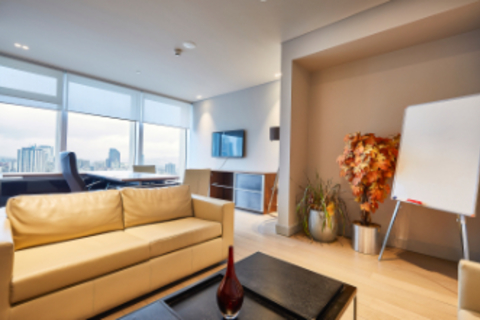 a living room filled with furniture and a large window