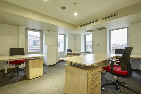 a room filled with furniture and a large window