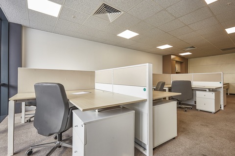 a bedroom with a desk and chair in a room