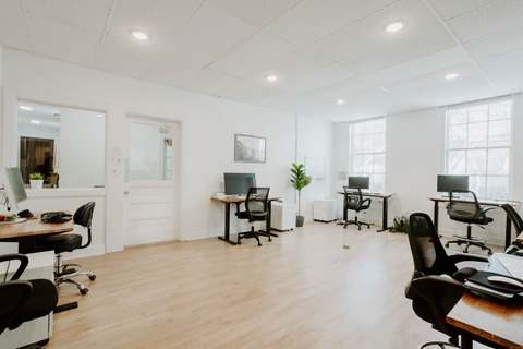 a living room filled with furniture and a wood floor