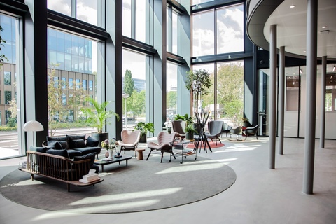 a living room filled with furniture and a large window