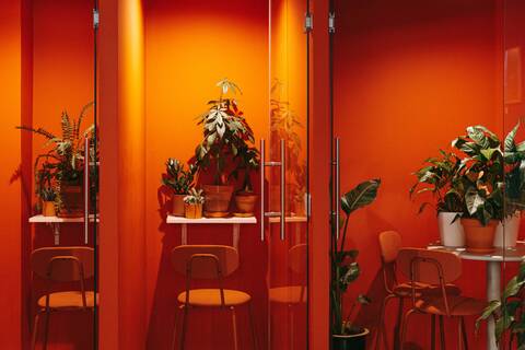 a room filled with furniture and vase of flowers on a table