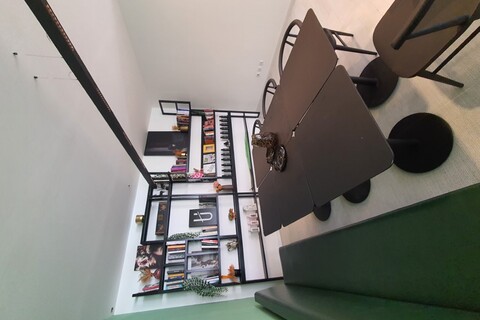 a desk with a computer and a chair in a room