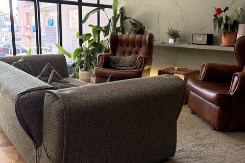 a room with a couch and chairs