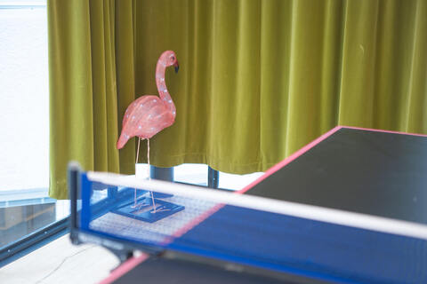 a pink flamingo on a table
