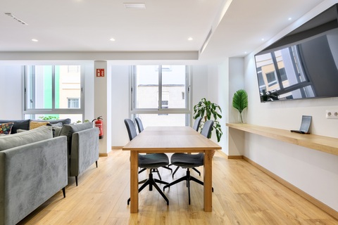 a living room filled with furniture and a large window