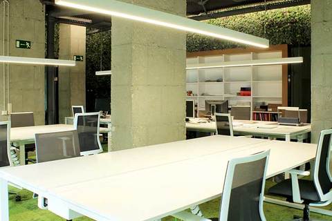 an office with a desk and chair in a room