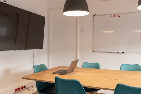 a bedroom with a desk and chair in a room