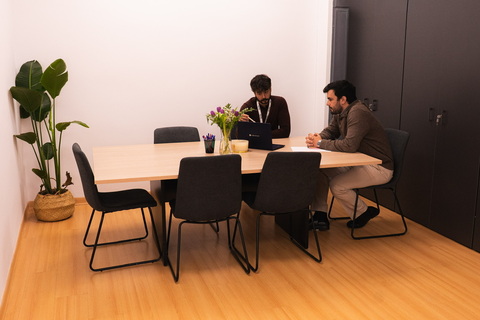 a person sitting at a table in a room