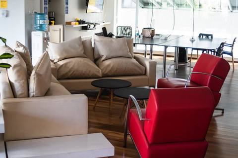 a living room filled with furniture and a large window