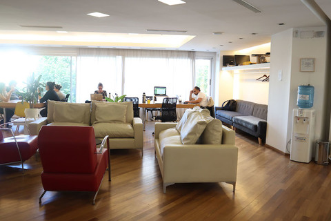 a living room filled with furniture and a large window