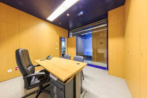 an office with a desk and chair in a room