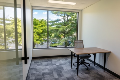 a room filled with furniture and a large window