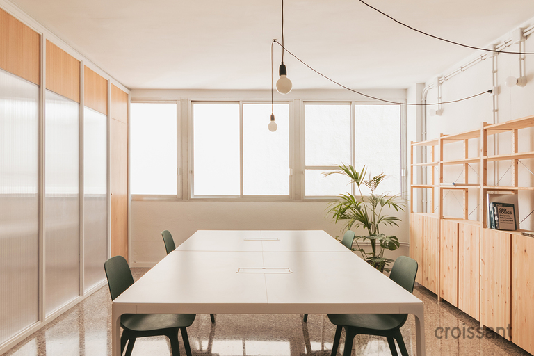 a room filled with furniture and a large window