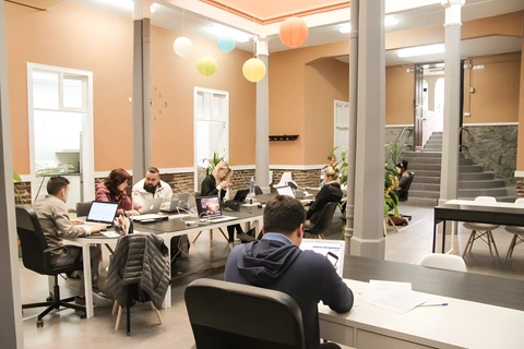 a group of people sitting at a table in a room