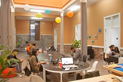 a group of people sitting at a table in a room